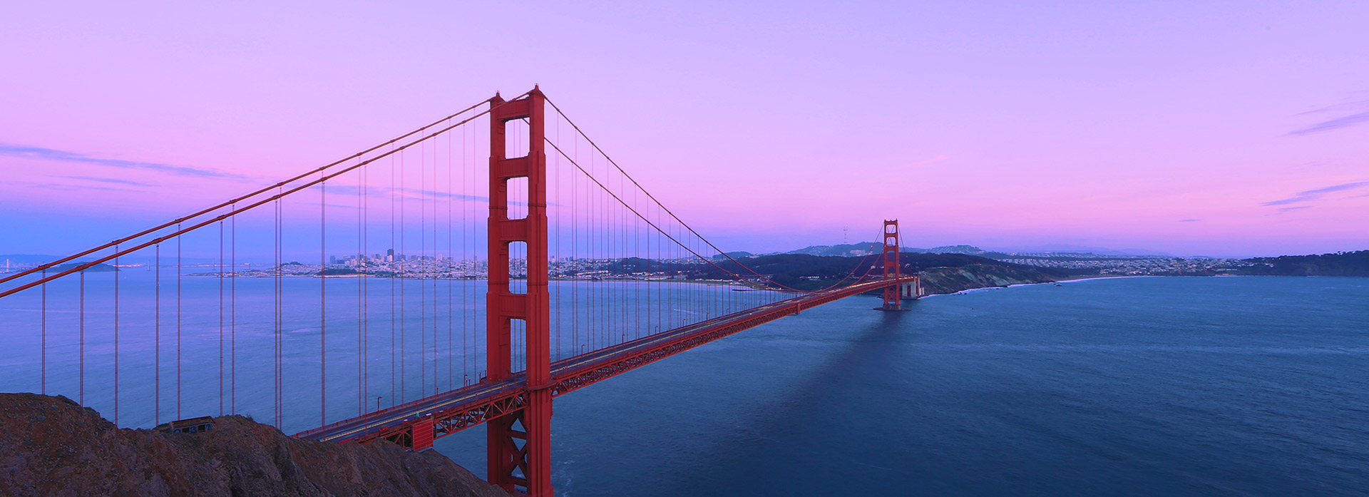 Golden Gate Bridge with a pink and purple sunset sky