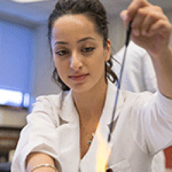 Chemistry student works with flame in the lab